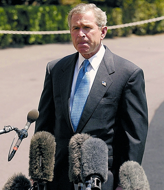 Reporters confront Bush about his recent bamboozling by a devious rabbit (below).